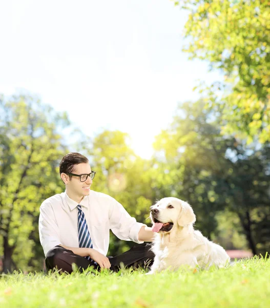 Man with dog in park on grass