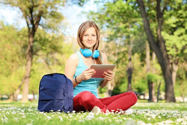 Student with headphones and tablet