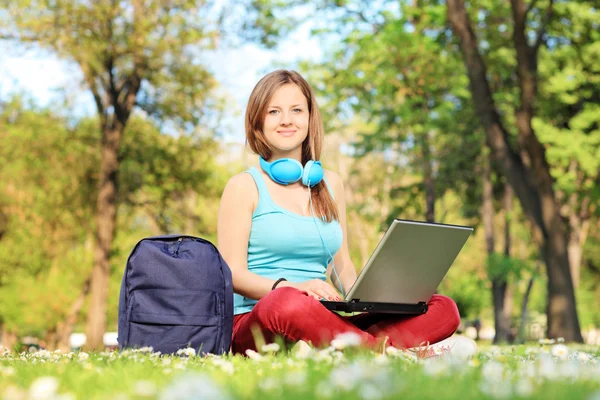 Female student relaxing in park