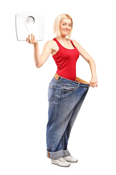 Weight loss female holding weight scale