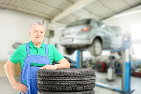 Mechanic posing on tires