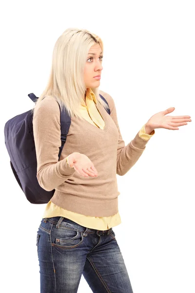 Blond female student with backpack gesturing - I do not know