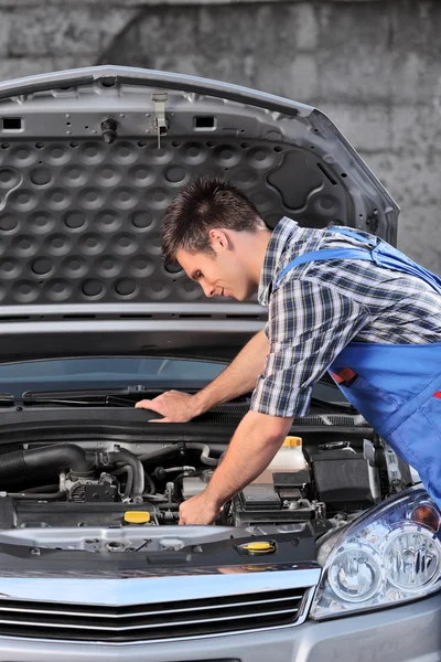 Mechanic examining an automobile