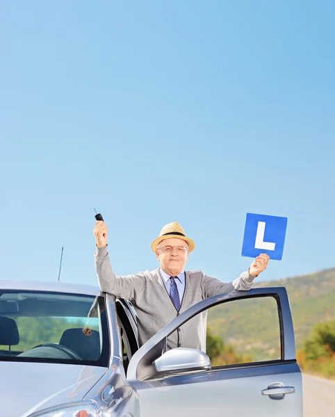 Man posing next to his car