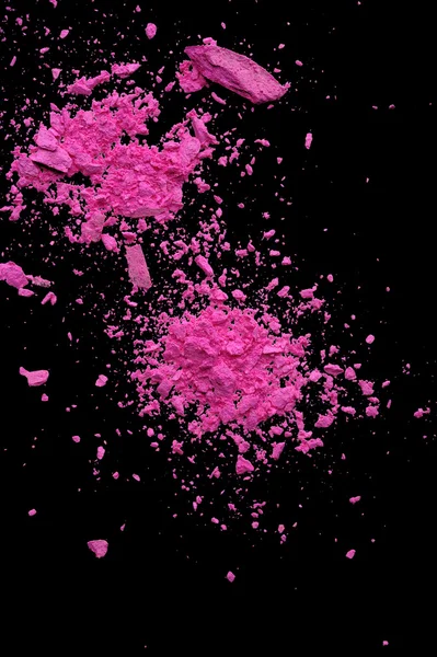 Explosion pink makeup powder on black background