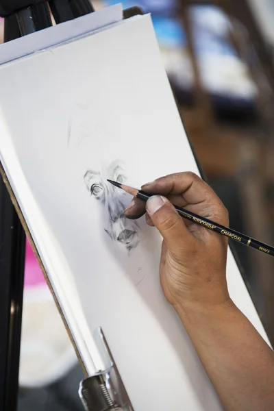 Artist paints a picture with a pencil