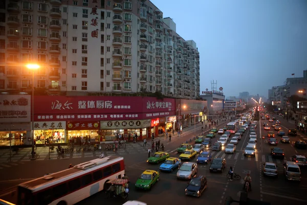 Sichuan, China: Cars and buses line the busy street