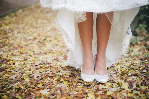 Bride\'s feet in white wedding shoes close up