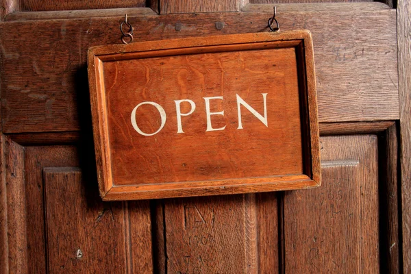 Open sign on old wooden door