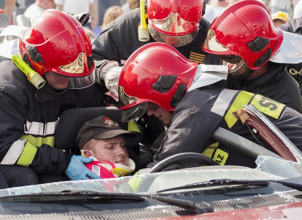 Emergency crew removing a victim from a car accident