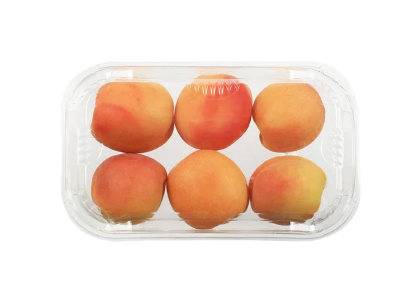 Apricots in plastic package, isolated - 图库照片