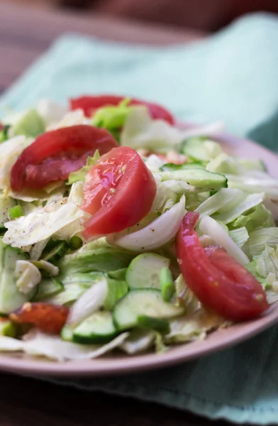 Salad with tomatoes, cabbage, cucumbers