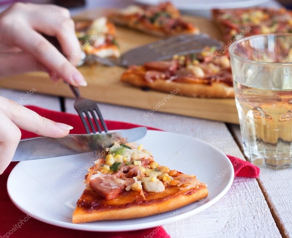 Eat pizza with a fork and knife — Stock Photo © haarmony 50422425