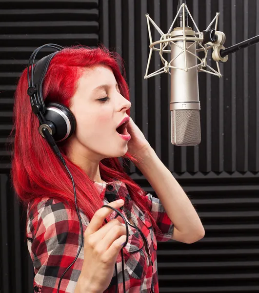 Young woman recording song