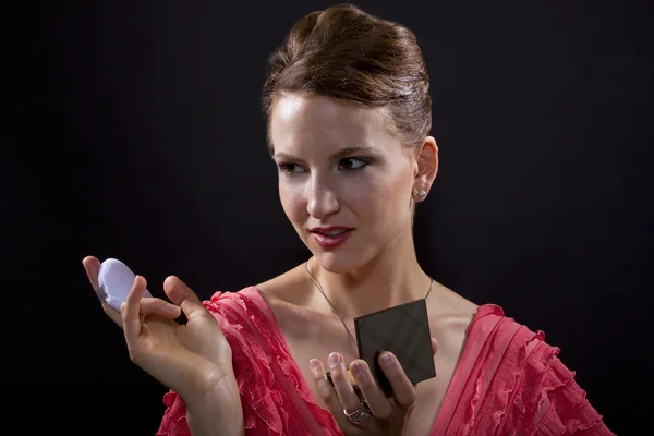 Woman applying foundation makeup