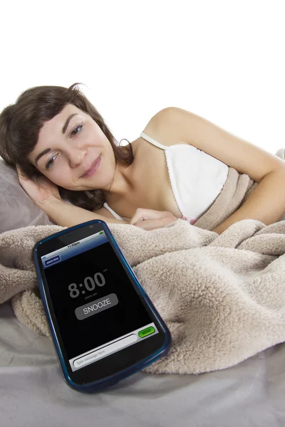 Female snoozing modern cell phone alarm clock