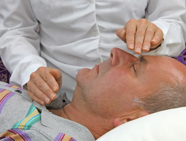 Healer balancing throat and third eye chakra