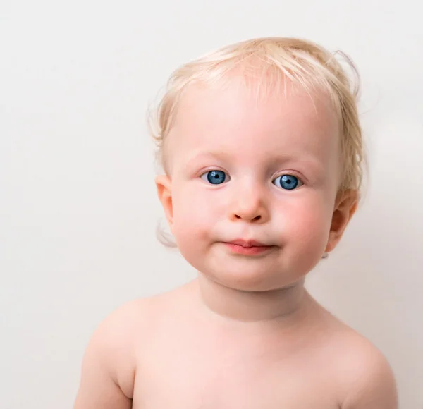Funny blond baby with blue eyes