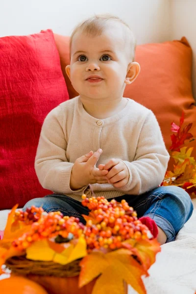 Funny baby with autumn fall leaves