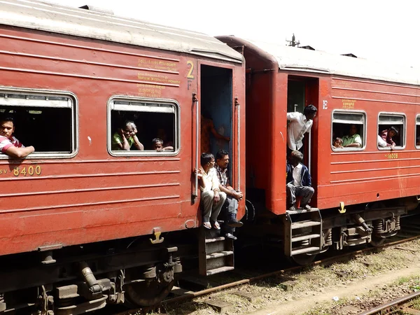 Asian third-class passengers in the red train, Sri Lanka