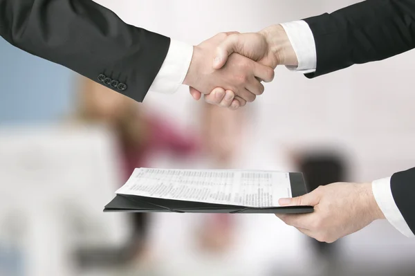 People shaking hands in a transaction