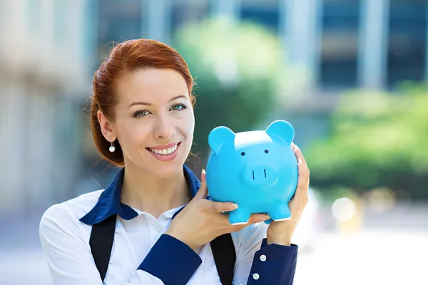 Happy woman, corporate employee holding piggy bank
