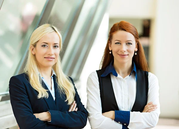 Portrait of two confident happy business women