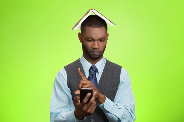 Man with phone, book over head