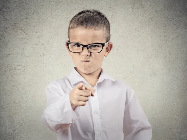 Angry bossy boy pointing finger at someone