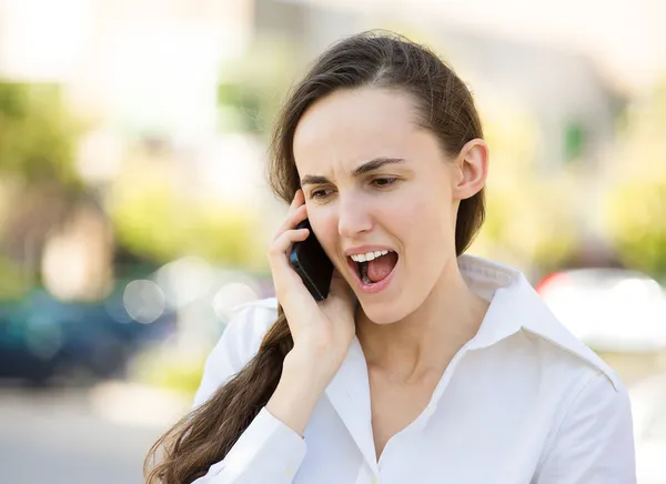 Angry woman talking on a phone