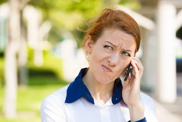 Unhappy woman talking on a phone