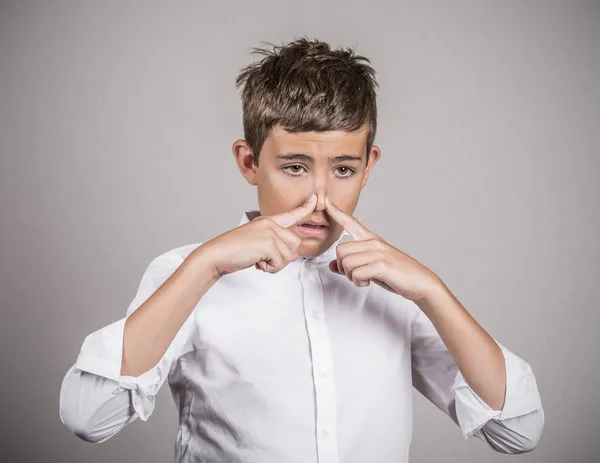 Teenager pinches his nose, bad smell