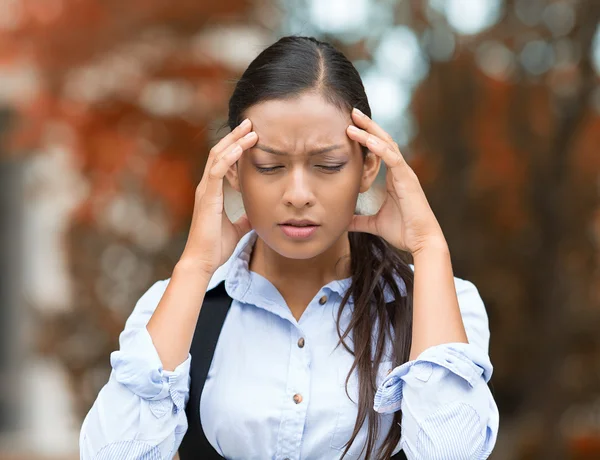 Stressed woman having headache