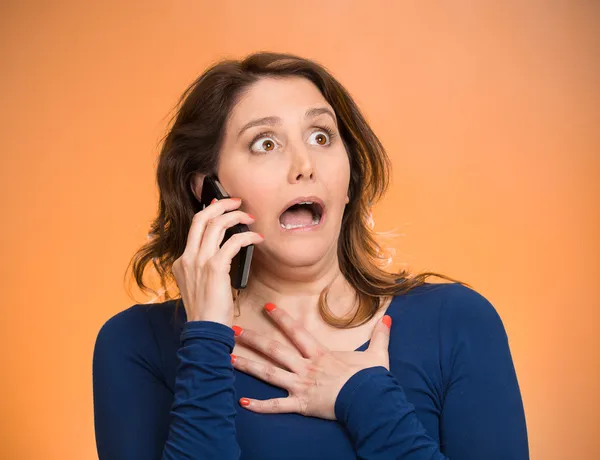 Woman receiving shocking news on a phone