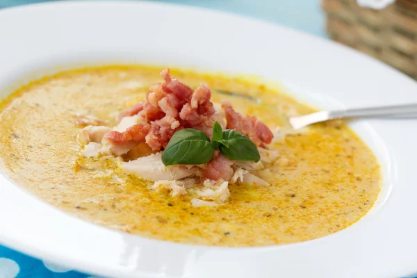 Indian soup with curry, bacon and basil