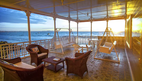 Beach house terrace lounge at sunset