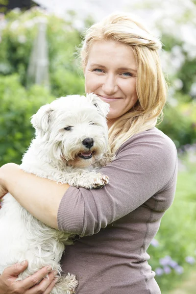 Portrait Of Woman With Pet Dog In Garden