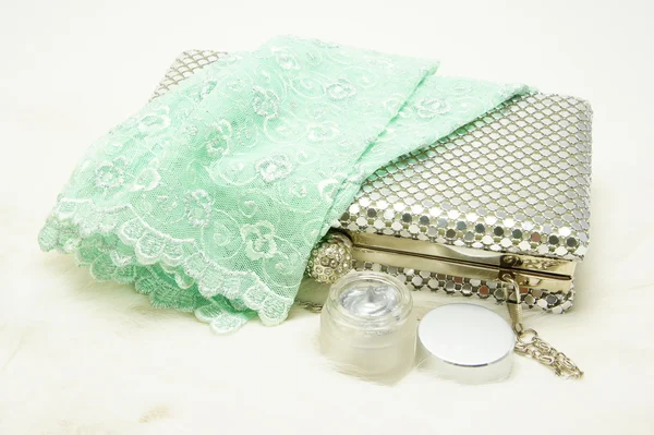 Evening bag with lace gloves and cosmetic.