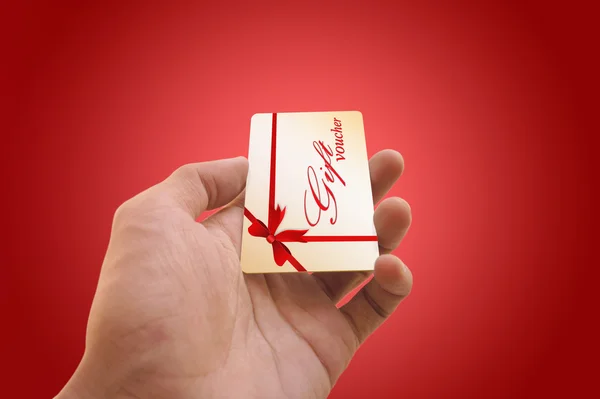 Hand holding a gift voucher card