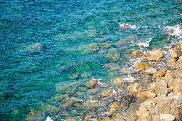 Rocky coast with clean blue see-through water. Cinque Terre Ital