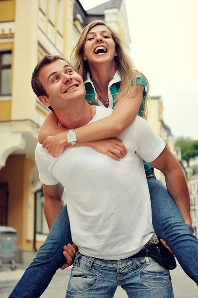 Couple in love having fun laughing and smiling at city