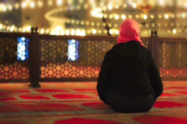 Muslim woman praying in a mosque