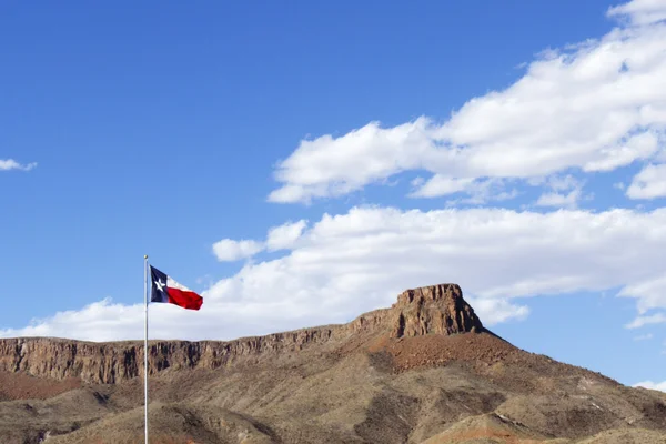 Texas State Flag with Blue Sky and Rock Mesa