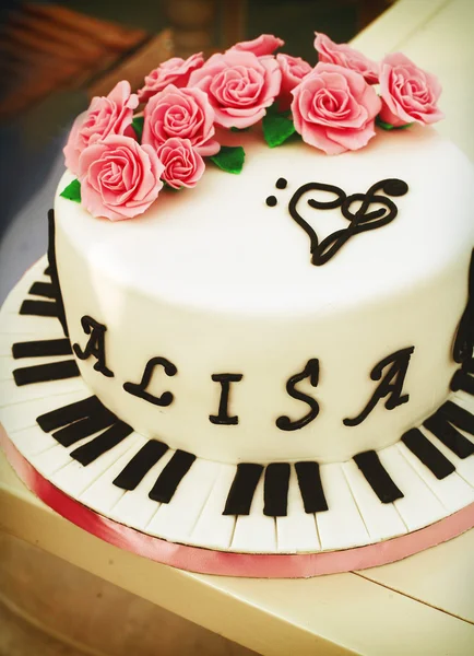 Creamy cake with piano keys, treble clef and roses