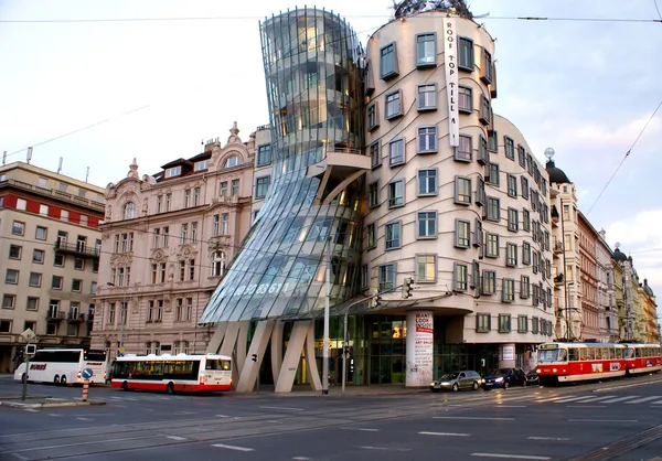 Street view with famous Dancing House and red tram