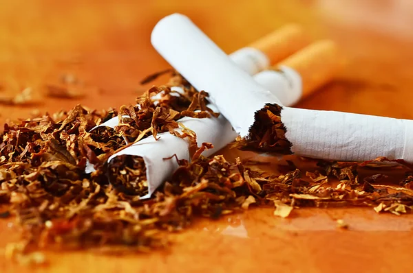 Broken cigarettes with a brown filter close up