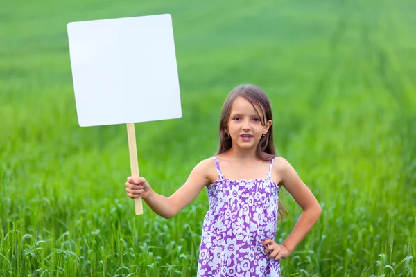 Little girl on neutral background holding sign