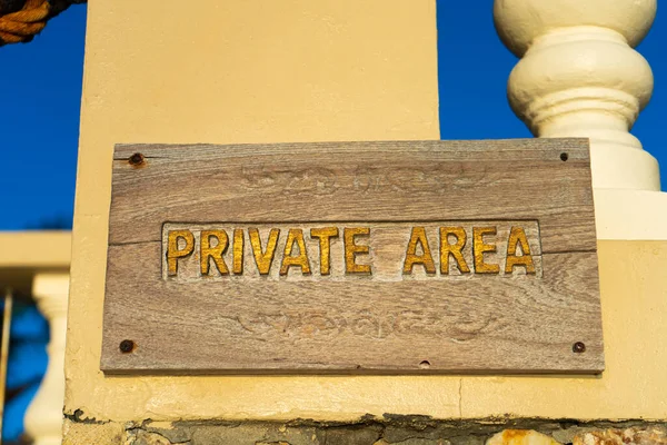 A sign warning about entering a private area, hanging on the fence of the property.