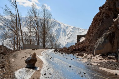 Dağlarda ilkbaharın başlarında. Kayalar yola düştü. Tehlikeli borazan yolu. Dağlarda kayalık.
