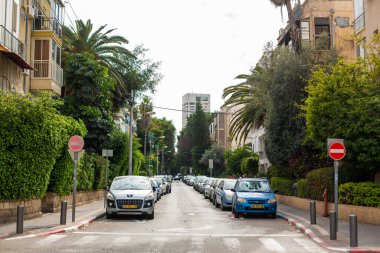 A large number of cars are parked on both sides of the street. Tel Aviv, Israel - 02.14.2015